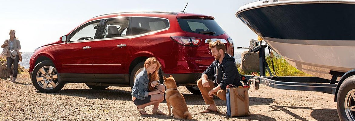 family pulling a boat with their Chevrolet SUV